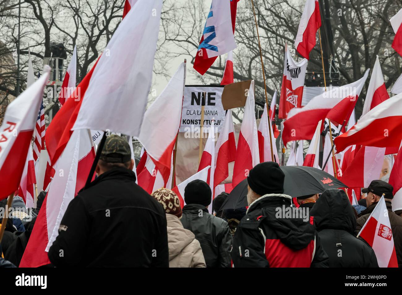 Warsaw, Poland, 10th of February, 2024. A crowd of people, holding Polish national flags and anti-government banners, led by far right media - Gazeta Polska and TV Republica and Law and Justice (Prawo i Sprawiedliwość - PIS) political party leaders stage a protest in support of current Constitutional Court Judges in front of the Court's building on Szucha Street. Poland goes through a constitutional crisis as current, centrist government says judges of Constitutional Court were illegally installed by former right-wing government. Right-wing opposition demonstrates a support of the Court Judges Stock Photo