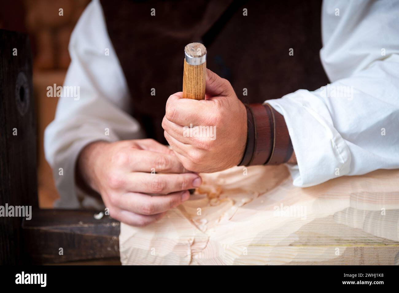 Wood worker with hand gouge working the Pine Stock Photo