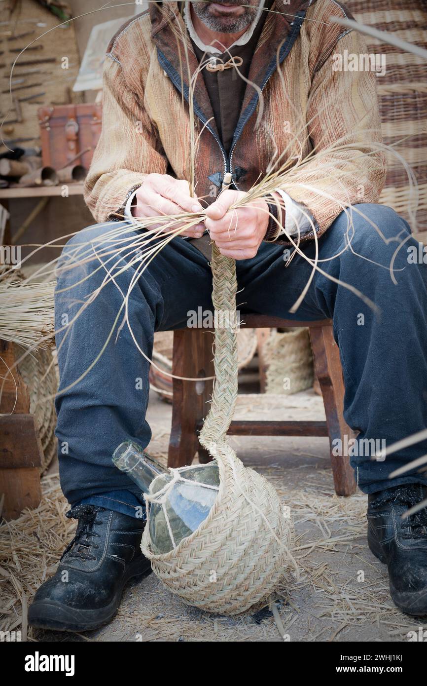 Close-up of man working wicker to make a final product Stock Photo