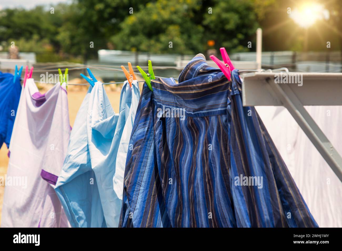 washing line with shirts hanging to dry at sunset Stock Photo