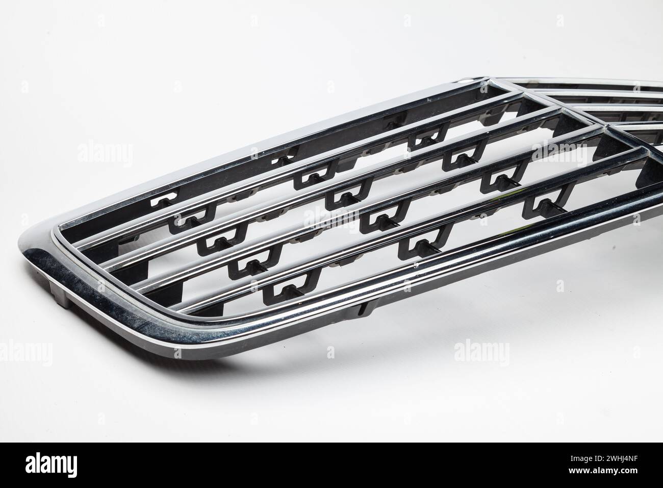 radiator grille on a white background made of shiny chromed metal is an ...