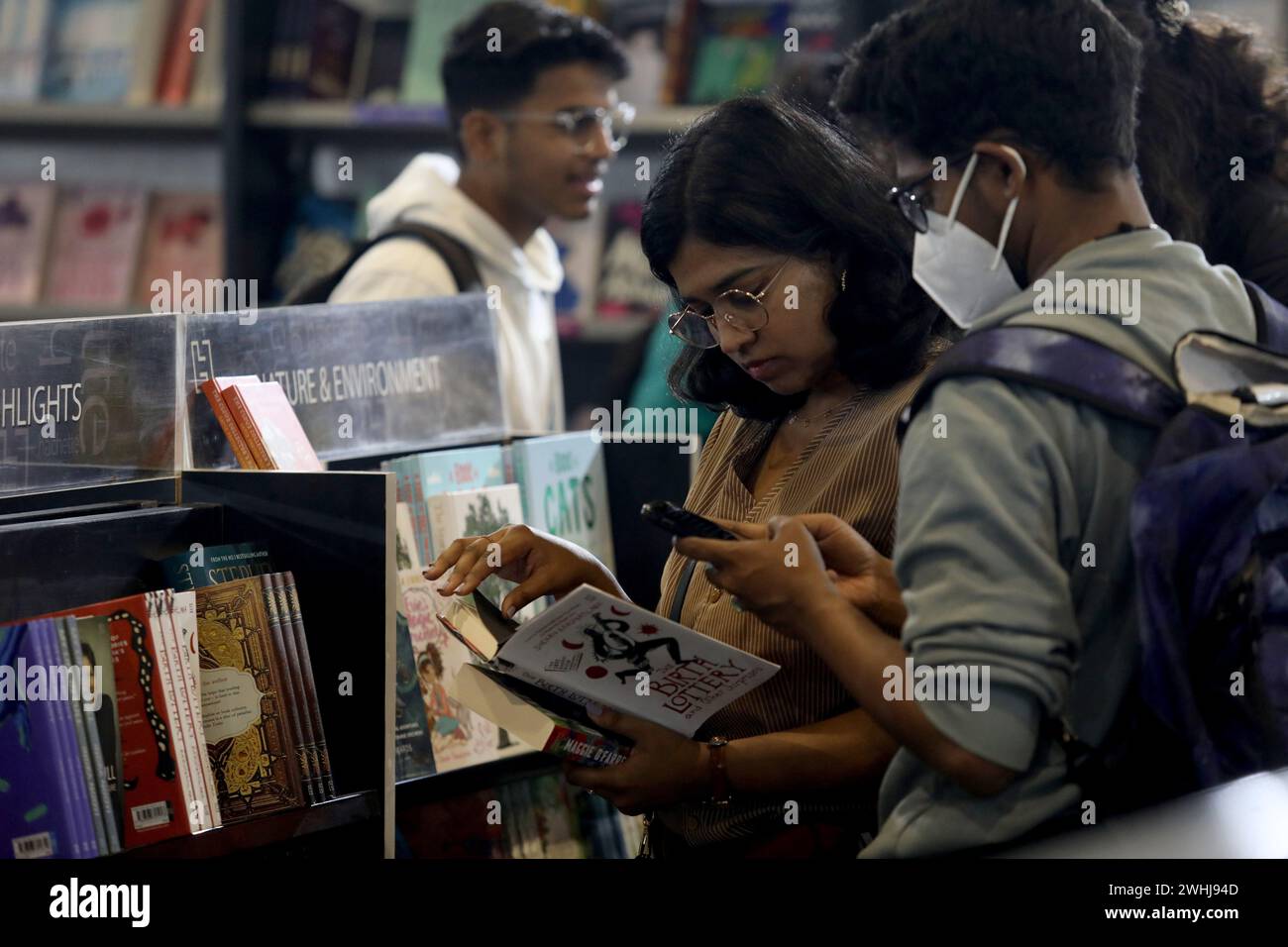 New Delhi, India. 10th Feb, 2024. A visitor reads a book at a book stall on the first day of the World Book fair 2024 with the theme 'MULTI LINGUAL INDIA' A living Tradition, at Pragati Maidan. The Kingdom of Saudi Arabia is the guest country for the in Book Fair 2024. The fair will continue til February 18 and wil host over 200 stalls of books with multiple languages. Credit: SOPA Images Limited/Alamy Live News Stock Photo