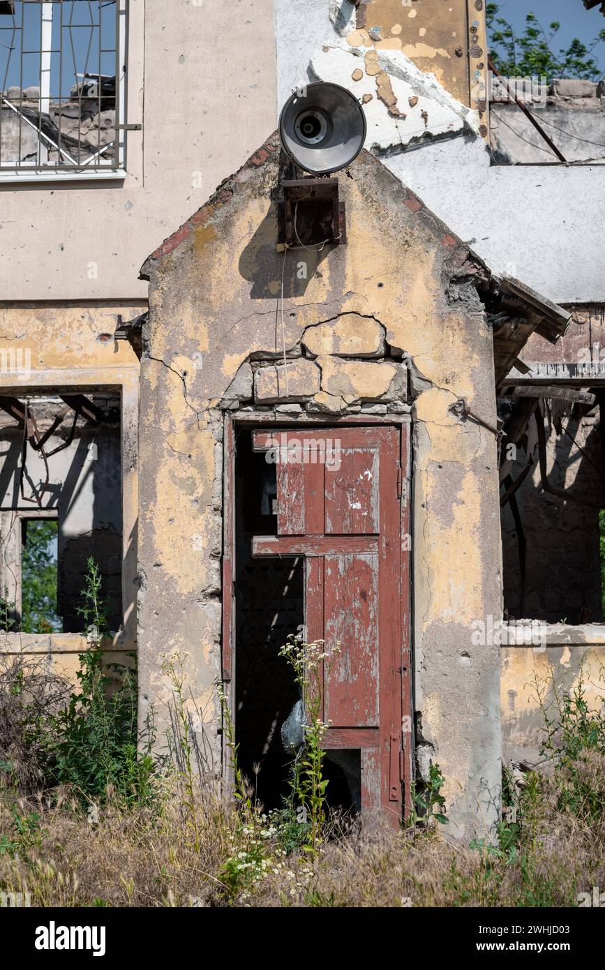 Old broken wooden door of a destroyed house in Ukraine Stock Photo