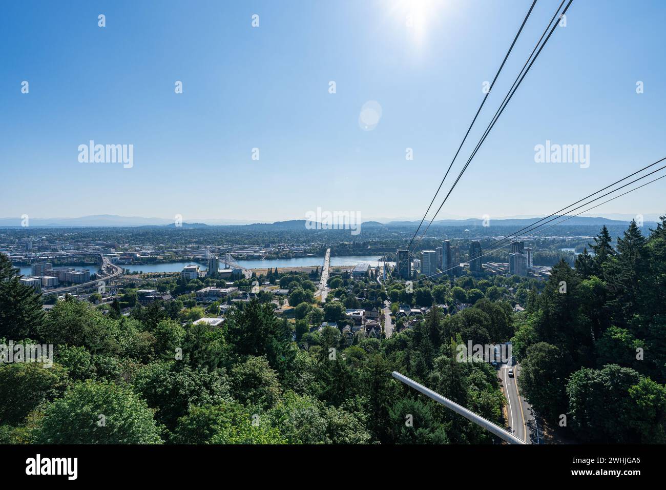 A photo of the Portland Aerial Tram with the Portland Skyline and Mt. Hood in the background on a clear sunny summer day. Stock Photo