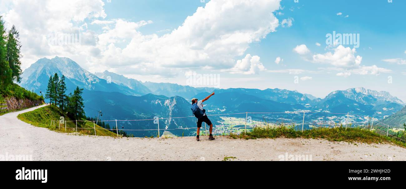 A Man is Hiking in the alps. cheering moving activity Dab. Jenner Mountain panorama - Berchtesgaden Stock Photo