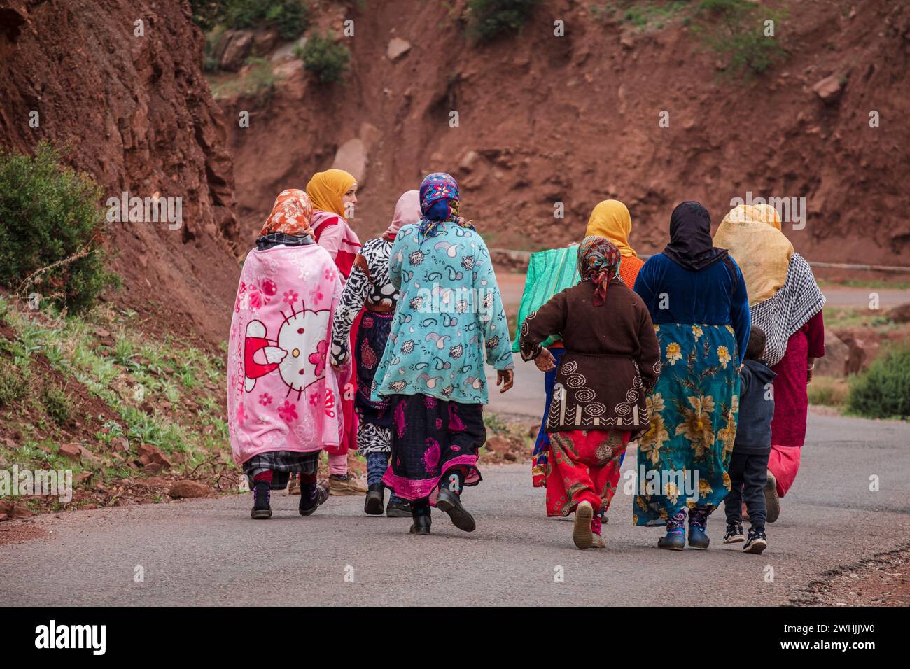 Group of berber women going to work on a paved road Stock Photo