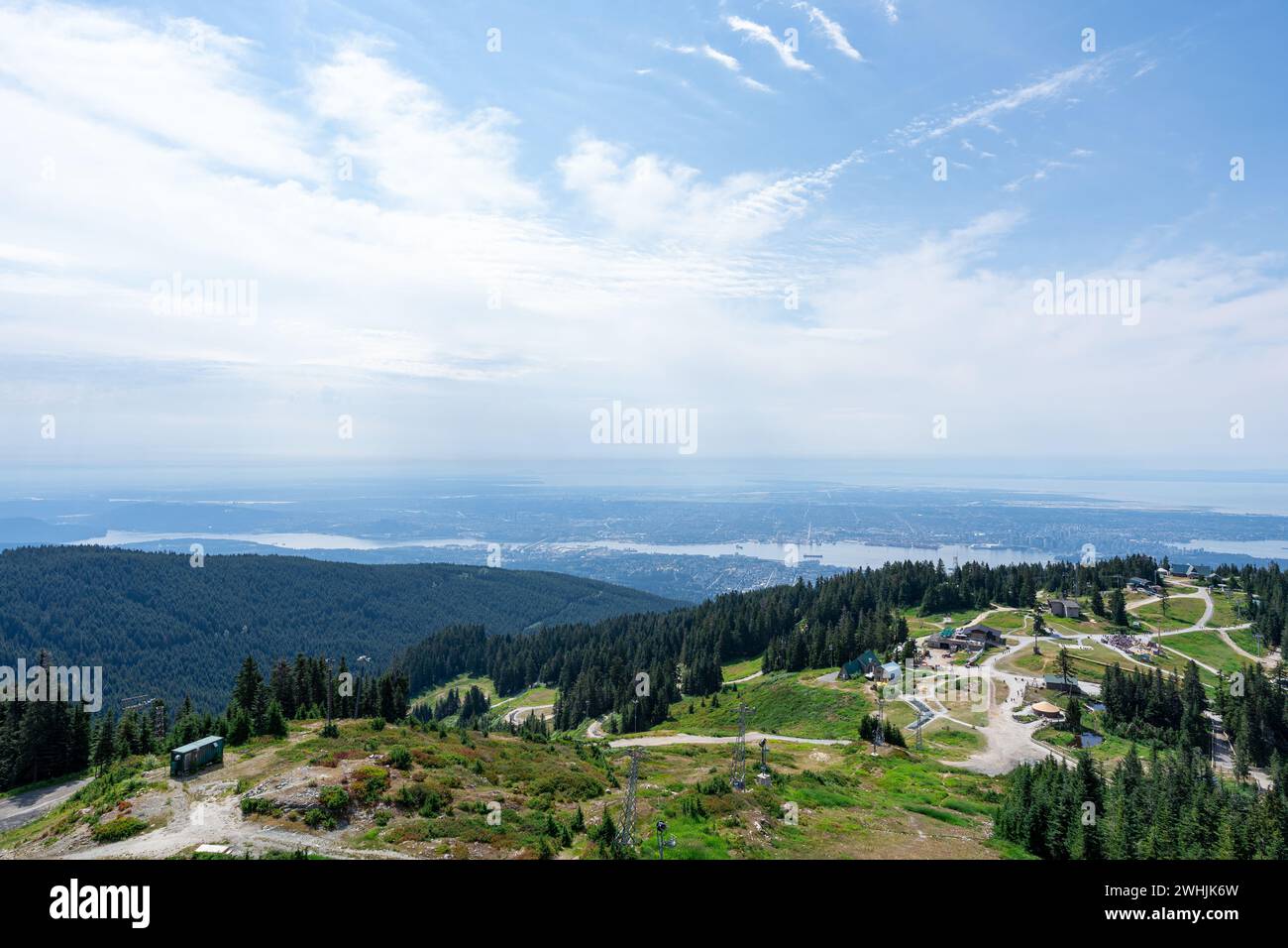 The view from the Grouse Mountain chairlift with Vancouver in the distant background. Stock Photo