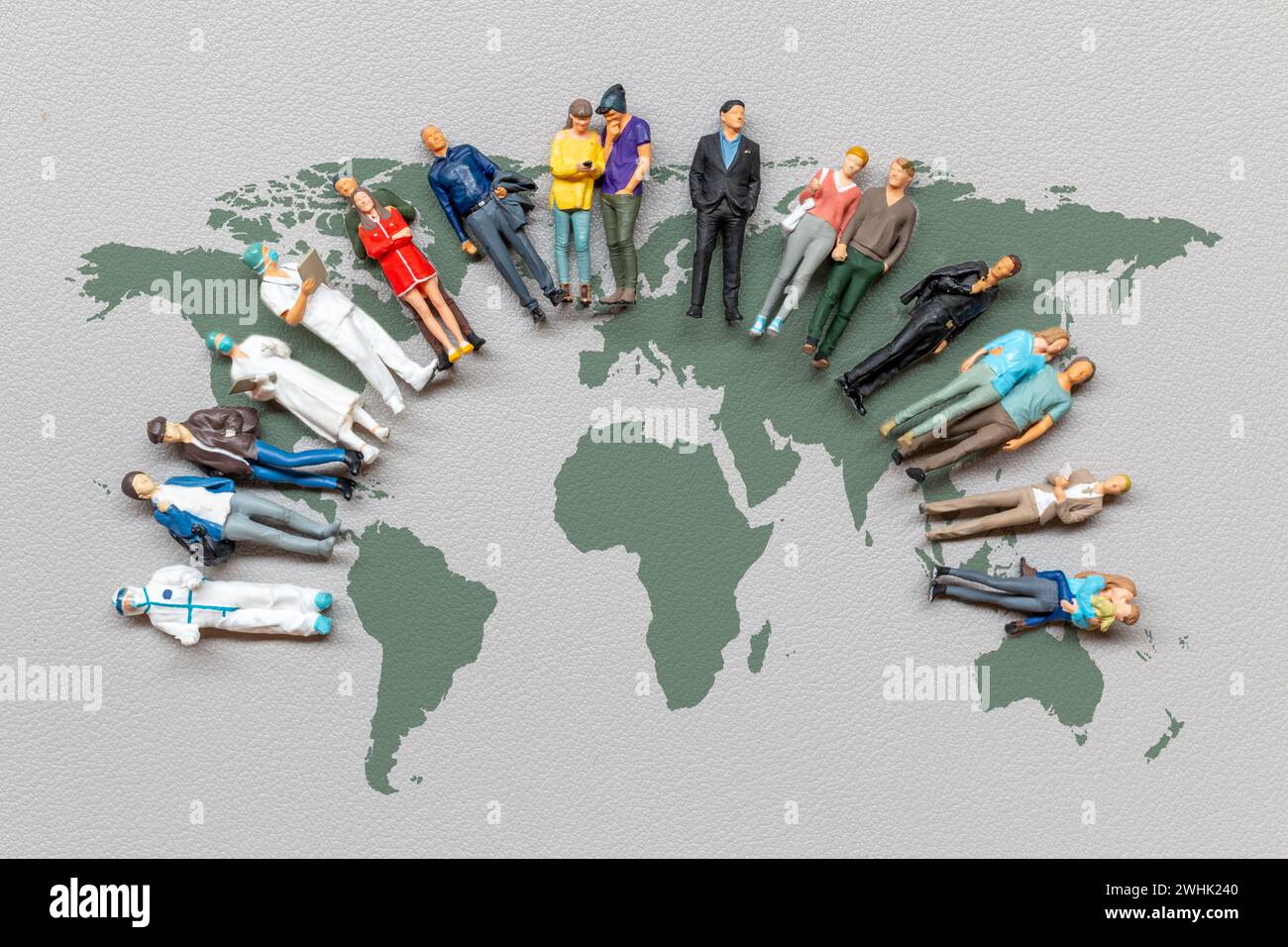 Miniature people standing on the world map with gray background Stock Photo