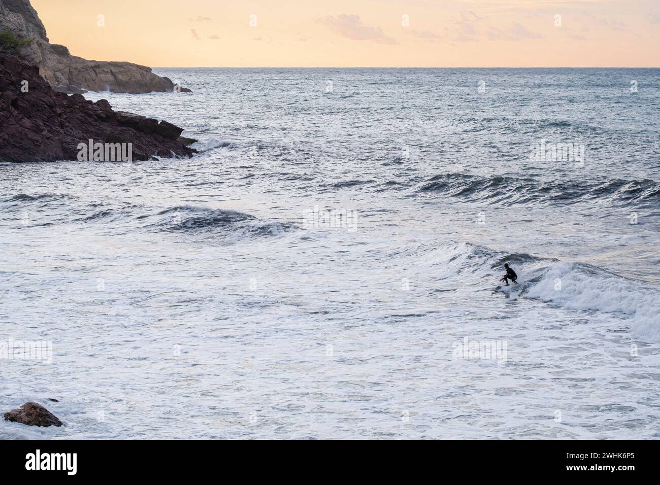 Surfer in  Son Bunyola beach Stock Photo