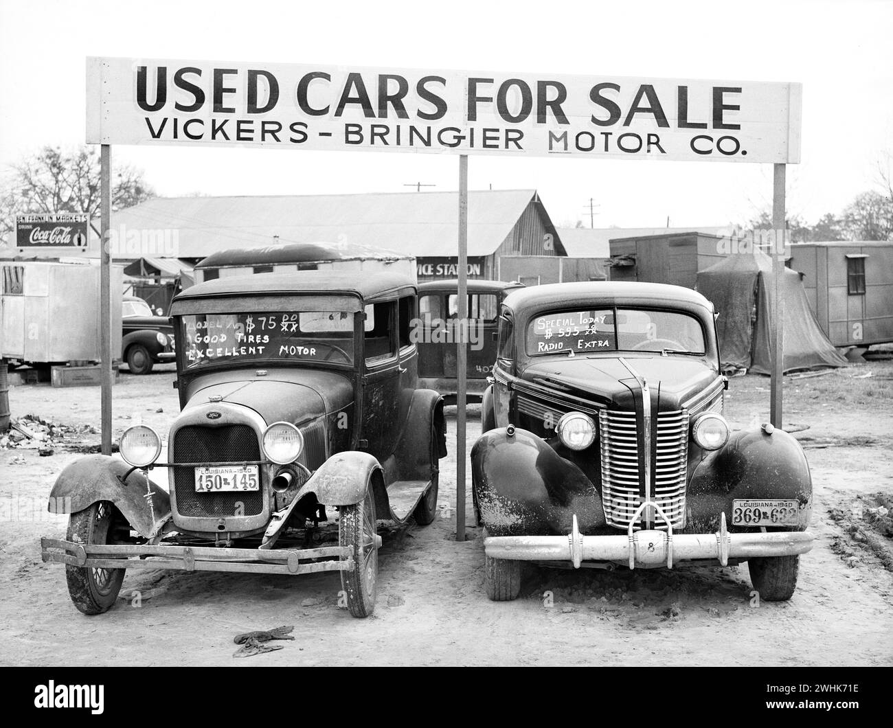 Used cars for sale with signs and prices at service station on main highway near Alexandria, Louisiana, USA, Marion Post Wolcott, U.S. Farm Security Administration, December 1940 Stock Photo
