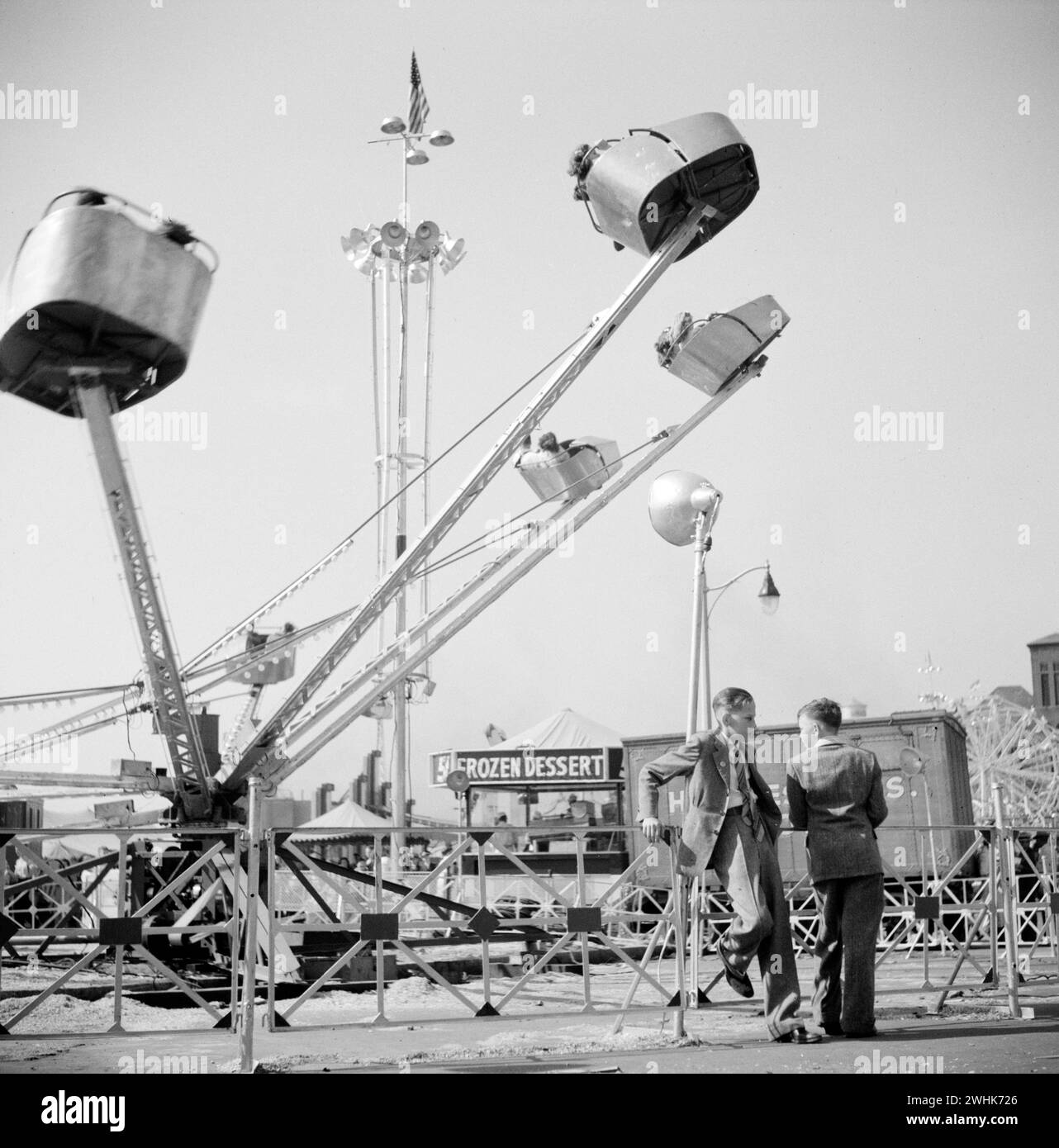 Two teen boys talking near carnival ride, Cotton Carnival, Memphis, Tennessee, USA, Marion Post Wolcott, U.S. Farm Security Administration, May 1940 Stock Photo