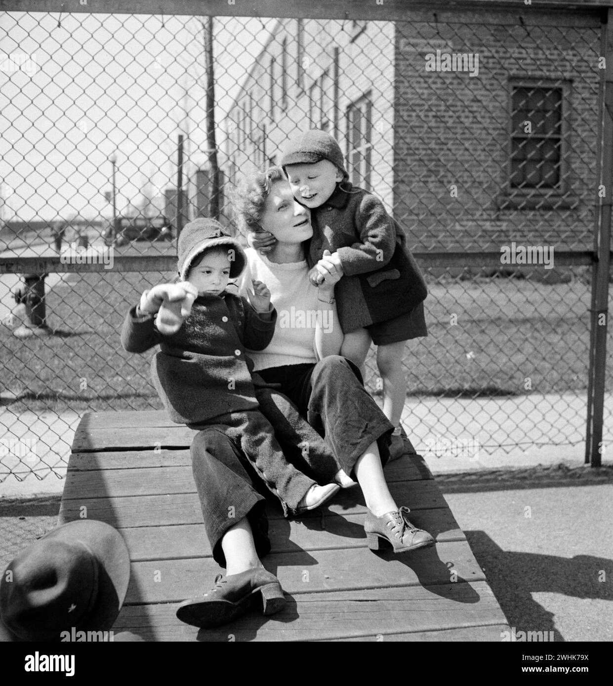 Mother with her two children at Lakeview nursery school for children of working mothers, operated by board of Education at tuition fee of three dollars weekly, Buffalo, New York, USA, Marjory Collins, U.S. Office of War Information, May 1942 Stock Photo