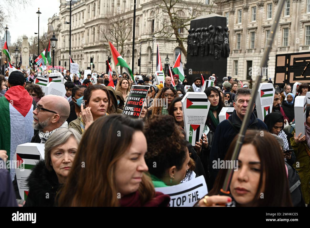 London, UK, 10 February 2024: Thousands of pro-Palestine supporters hold hundreds of paper coffins written with the names of children killed by Benjamin Netanyahu and Israeli soldiers. A rally was held by health workers for Palestine to demand a refund for UNRWA opposite Downing Street. Protesters allege the UK government's complicity in the Gaza genocide and demand that the UK government stop arming Israel UK fighter jets dropping bombing killing Palestians children and end the fund immediately. Health workers for Palestine are demanding justice for their health workers against the Israeli wa Stock Photo