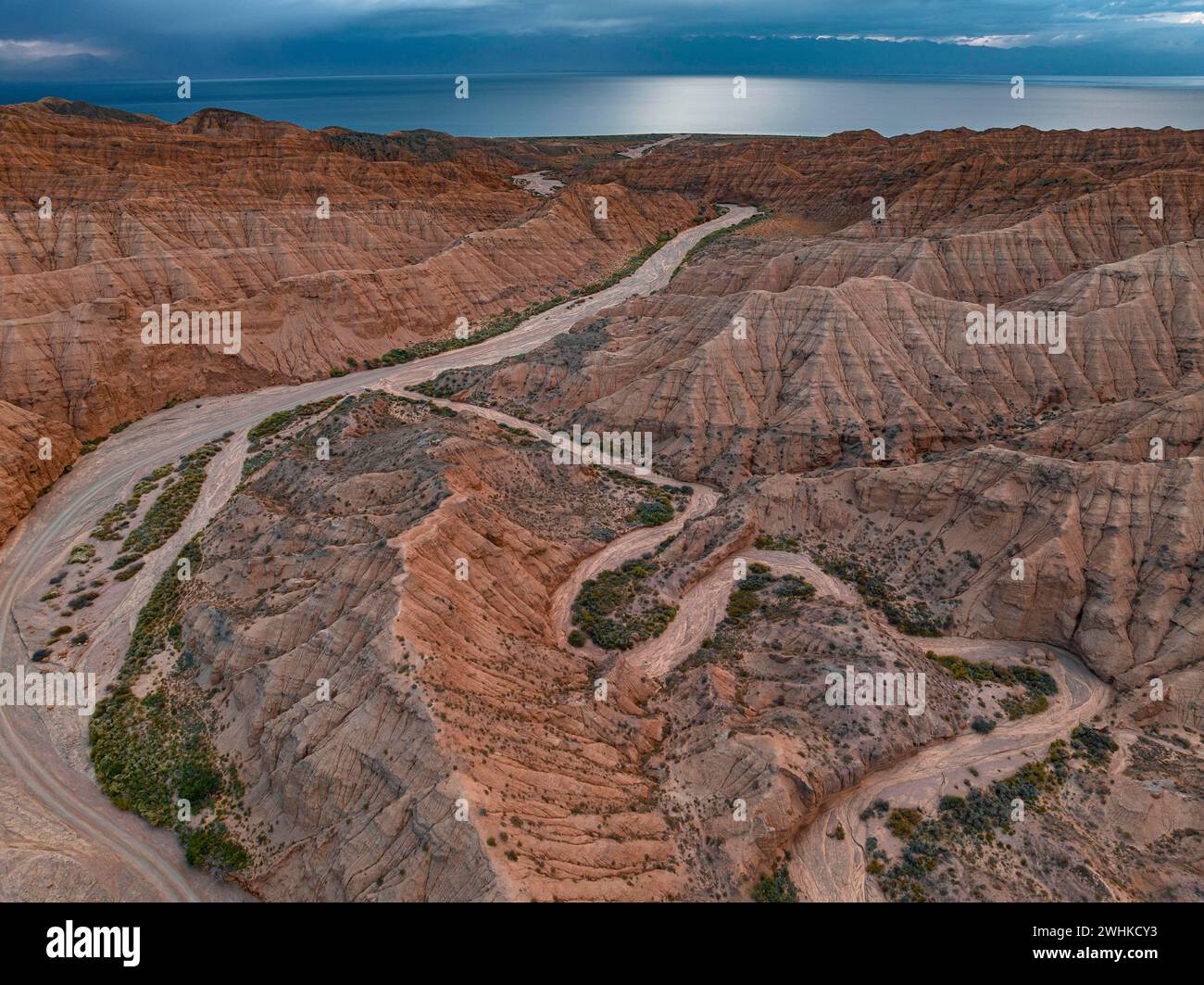 River bed runs through a landscape of eroded hills, badlands, Issyk Kul ...