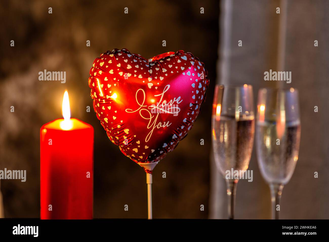 Heart balloon, candle and champagne glasses Stock Photo