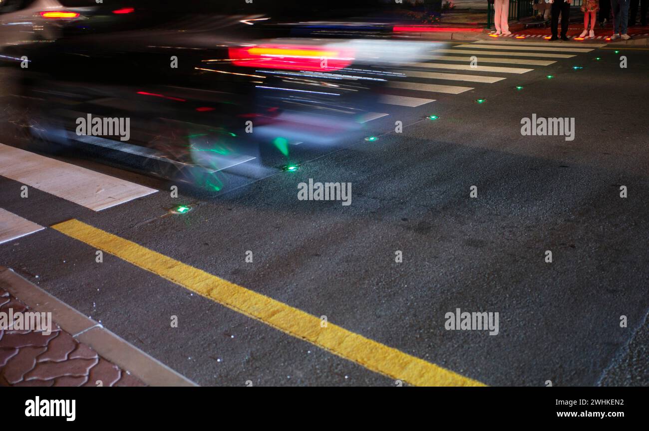 Night shot, pedestrian crossing, zebra crossing, against smartphone junkies, with ground traffic light, ground traffic light, LED lights red and Stock Photo