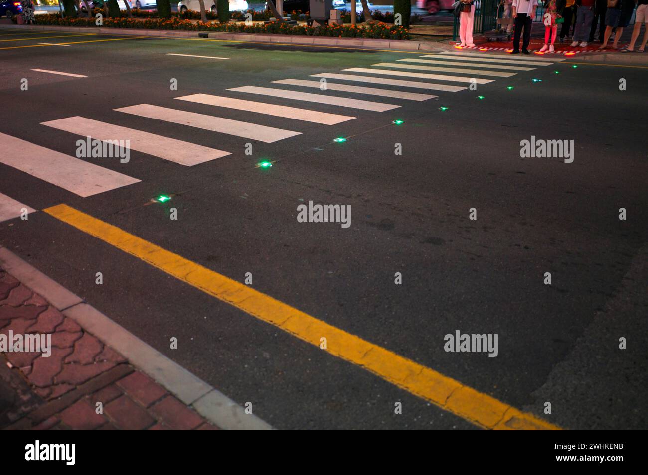 Night shot, pedestrian crossing, zebra crossing, against smartphone junkies, with ground traffic lights, ground traffic lights, LED lights red and Stock Photo