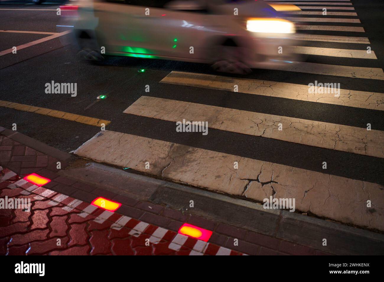 Night shot, pedestrian crossing, zebra crossing, against smartphone junkies, with ground traffic light, ground traffic light, LED lights red and Stock Photo