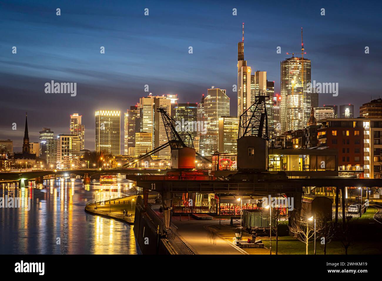 Skyline in the evening, skyscrapers of the banking district, historic harbour cranes at Weseler Werft, Frankfurt am Main, Hesse, Germany Stock Photo