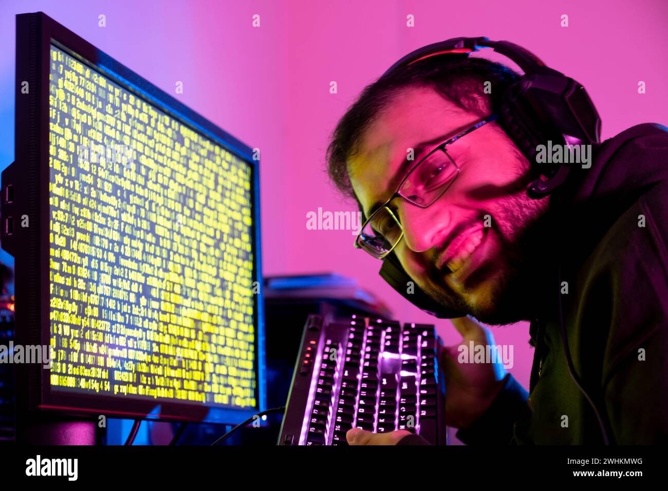 arabic guy working on some code trying to solve the problem Stock Photo