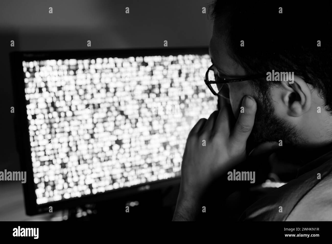 arabic guy working on some code trying to solve the problem Stock Photo