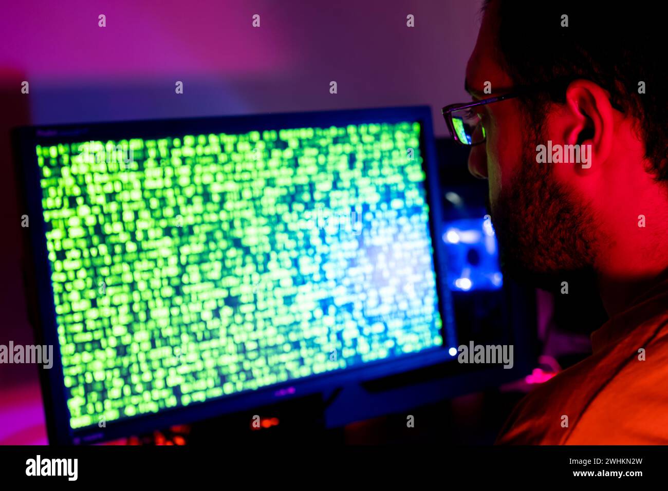 arabic guy working on some code trying to solve the problem Stock Photo