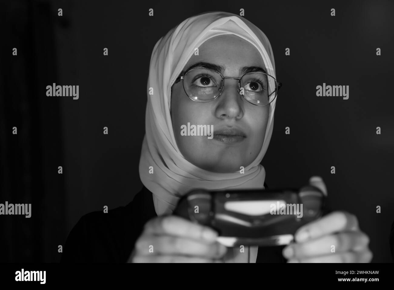 arabic muslim girl playing console games Stock Photo