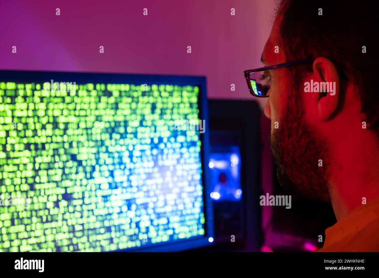 arabic guy working on some code trying to solve the problem Stock Photo