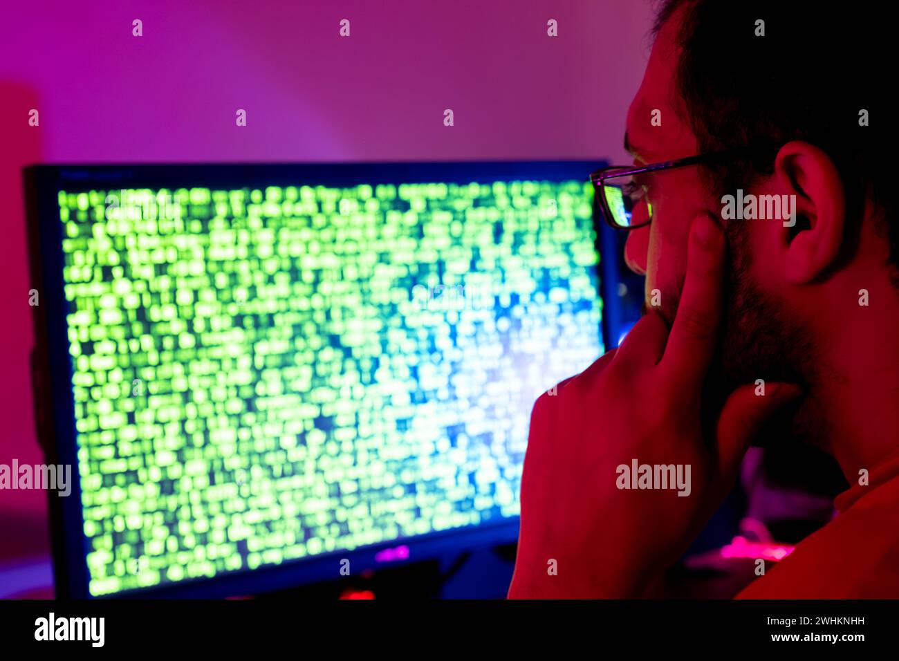 arabic guy working on some code trying to solve the problem Stock Photo