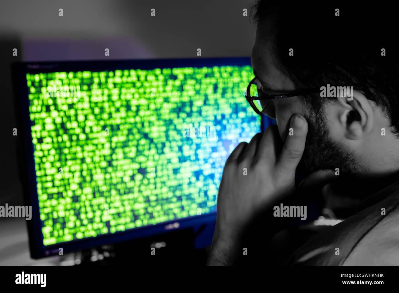 arabic guy working on some code trying to solve the problem Stock Photo