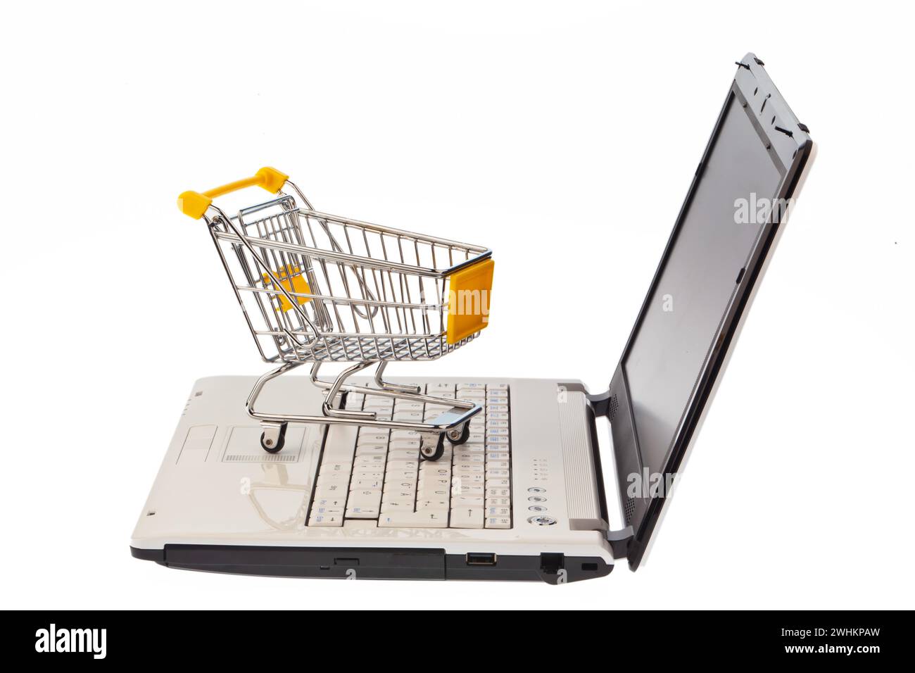 A shopping trolley and computer keyboard. Symbolising shopping on the Internet and online shopping, laptop Stock Photo