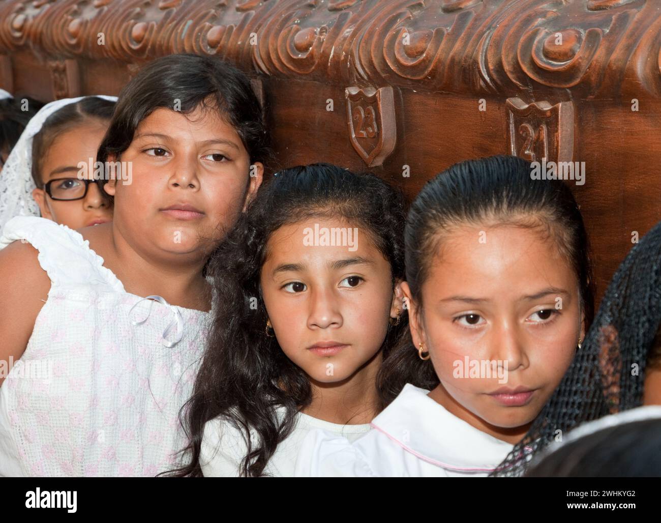 Antigua, Guatemala.  Semana Santa (Holy Week).  Young Girls Carry an Anda (Float) in a Religious Procession. Stock Photo