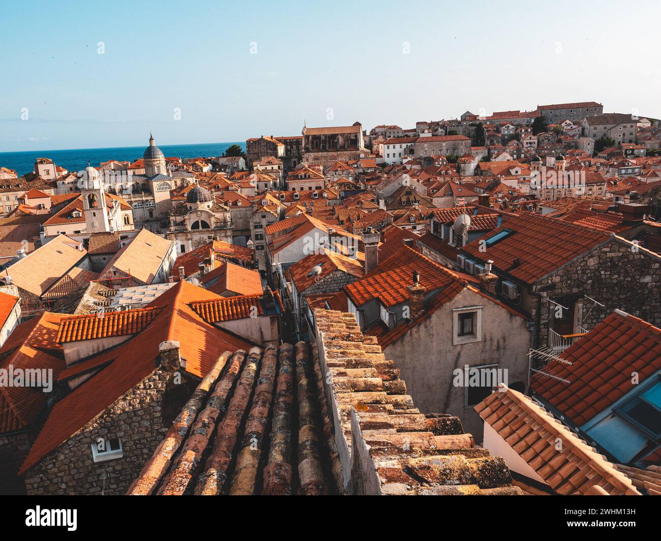 Red roofs adorned with vibrant red and orange tiles Stock Photo