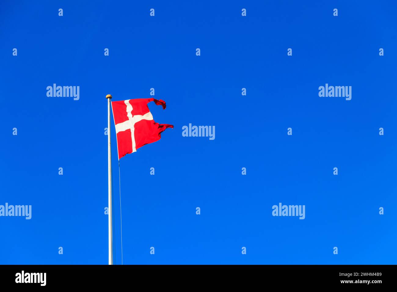 Flag of Denmark against blue sky Stock Photo