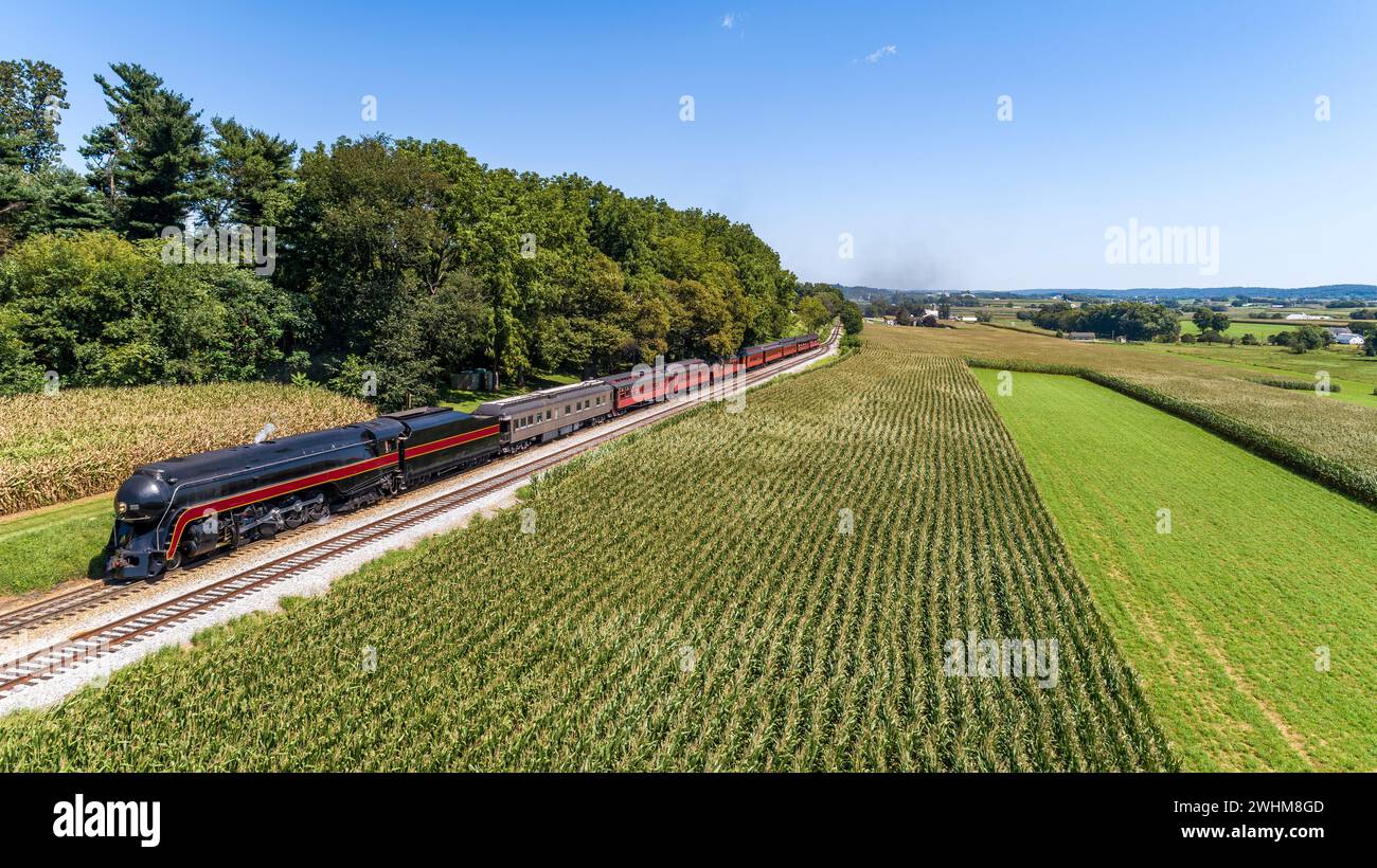 Drone View of an Antique Streamlined Steam Passenger Train Passing Thru Corn Fields Stock Photo