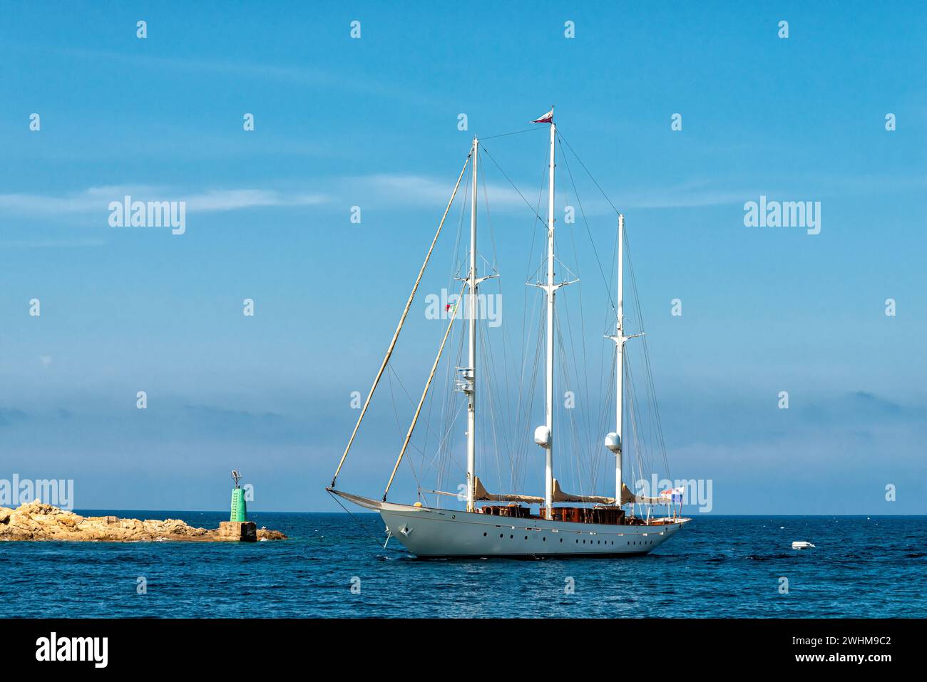 Luxury sailing yacht entering a harbour in the Mediterranean Sea Stock Photo