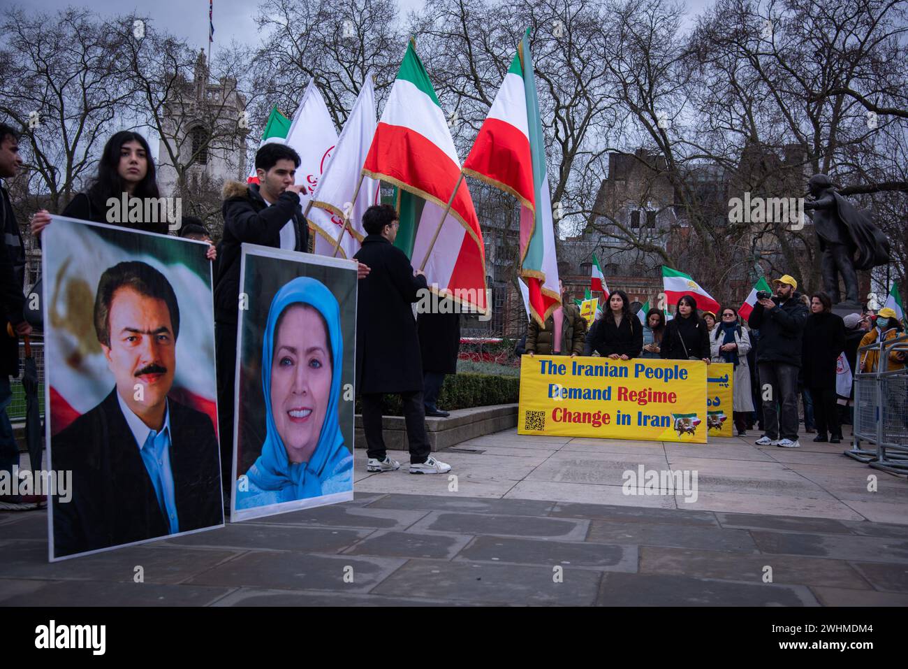London, UK. 10th Feb, 2024. Protestors hold placards and Iranian flags ...