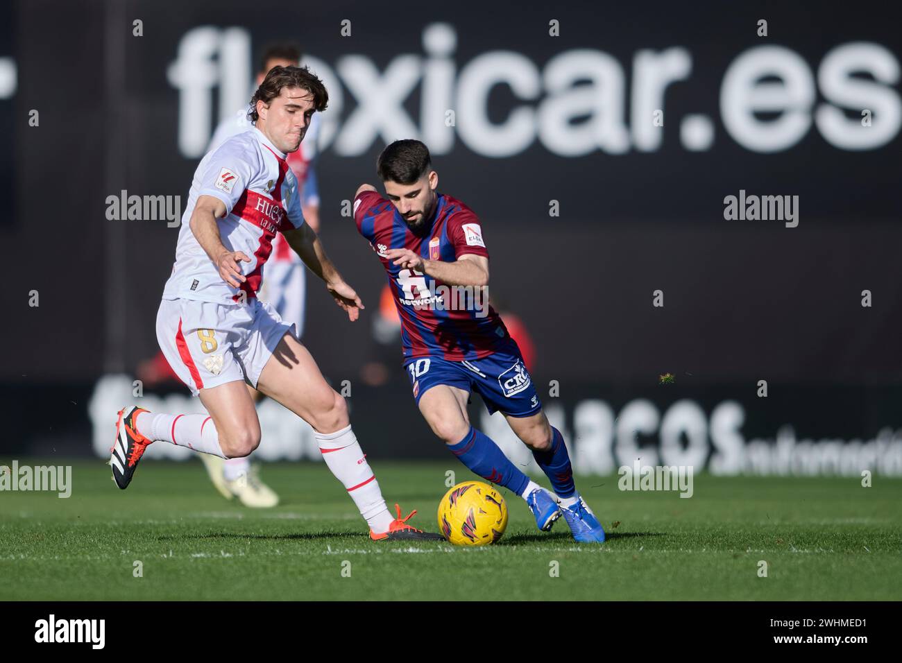 ELDA, SPAIN - FEBRUARY 10: Javi Martinez Attacking Midfield of SD Huesca competes for the ball with Cris Montes of CD Eldense during the LaLiga Hypermotion match between CD Eldense and SD Huesca at Nuevo Pepico Amat Stadium on February 10, 2024 in Elda, Spain. (Photo by Francisco Macia/Photo Players Images) Stock Photo