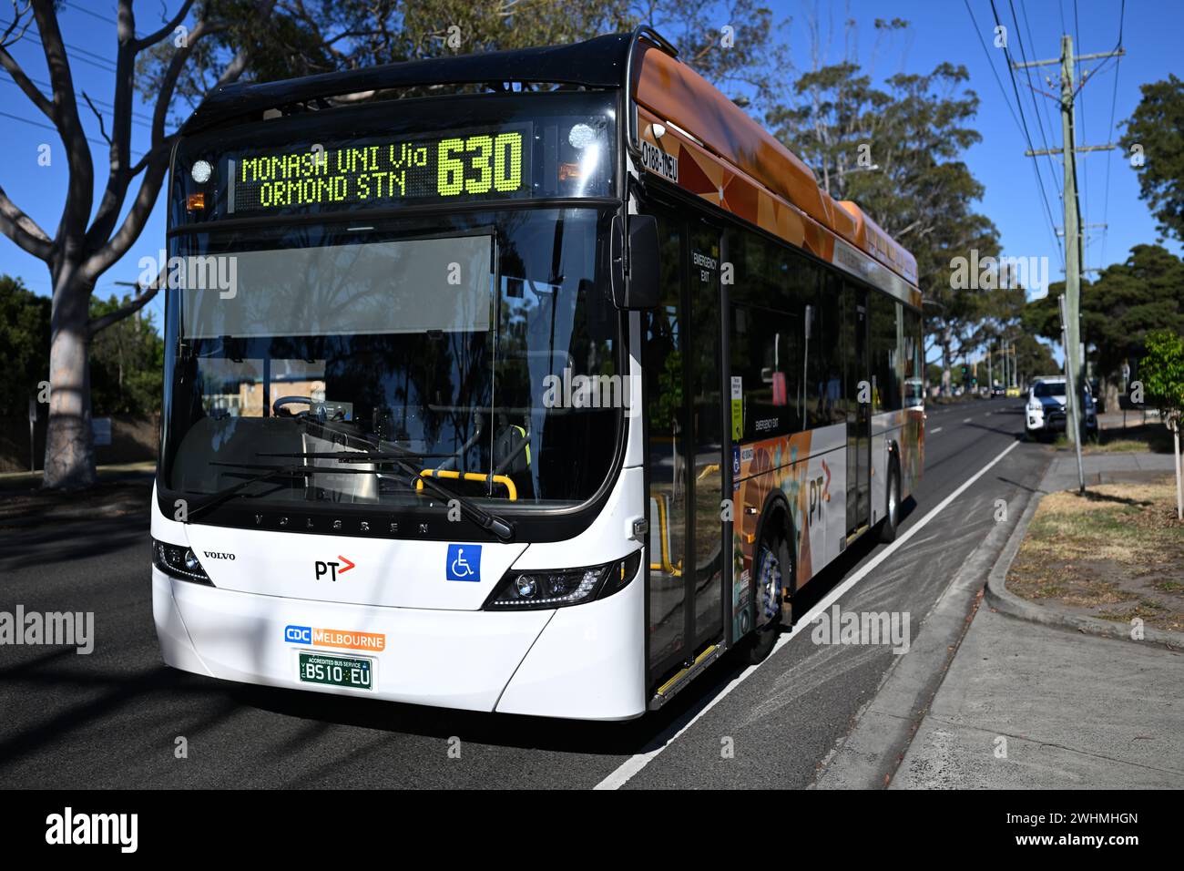 Front view of a Volvo BZL electric bus, operated by CDC Melbourne, as it heads to Monash University during a sunny day Stock Photo