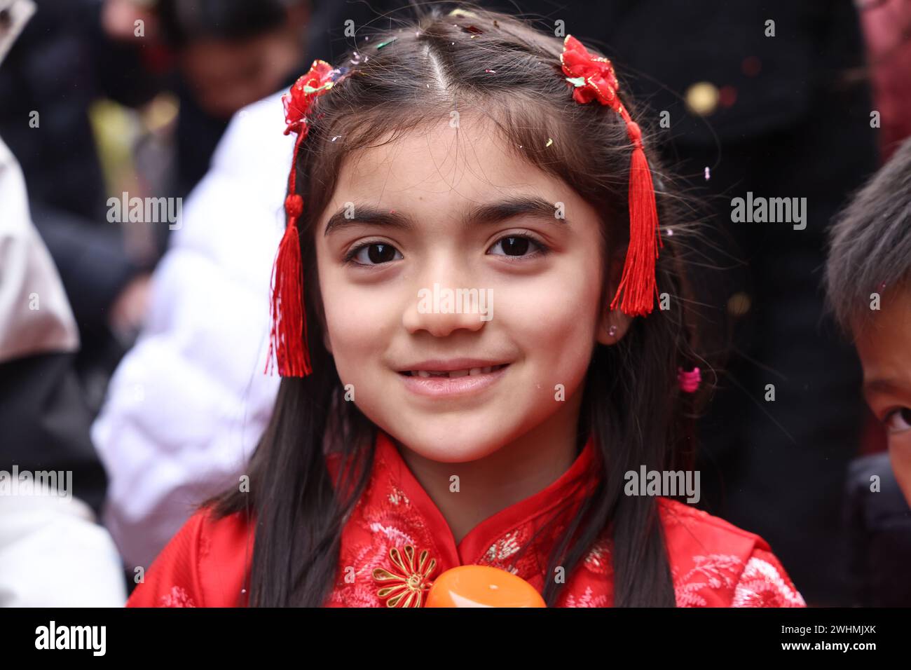 Children Dressed In Traditional Chinese Red Clothing Celebrate The children-dressed-in-traditional-chinese-red-clothing-celebrate-the