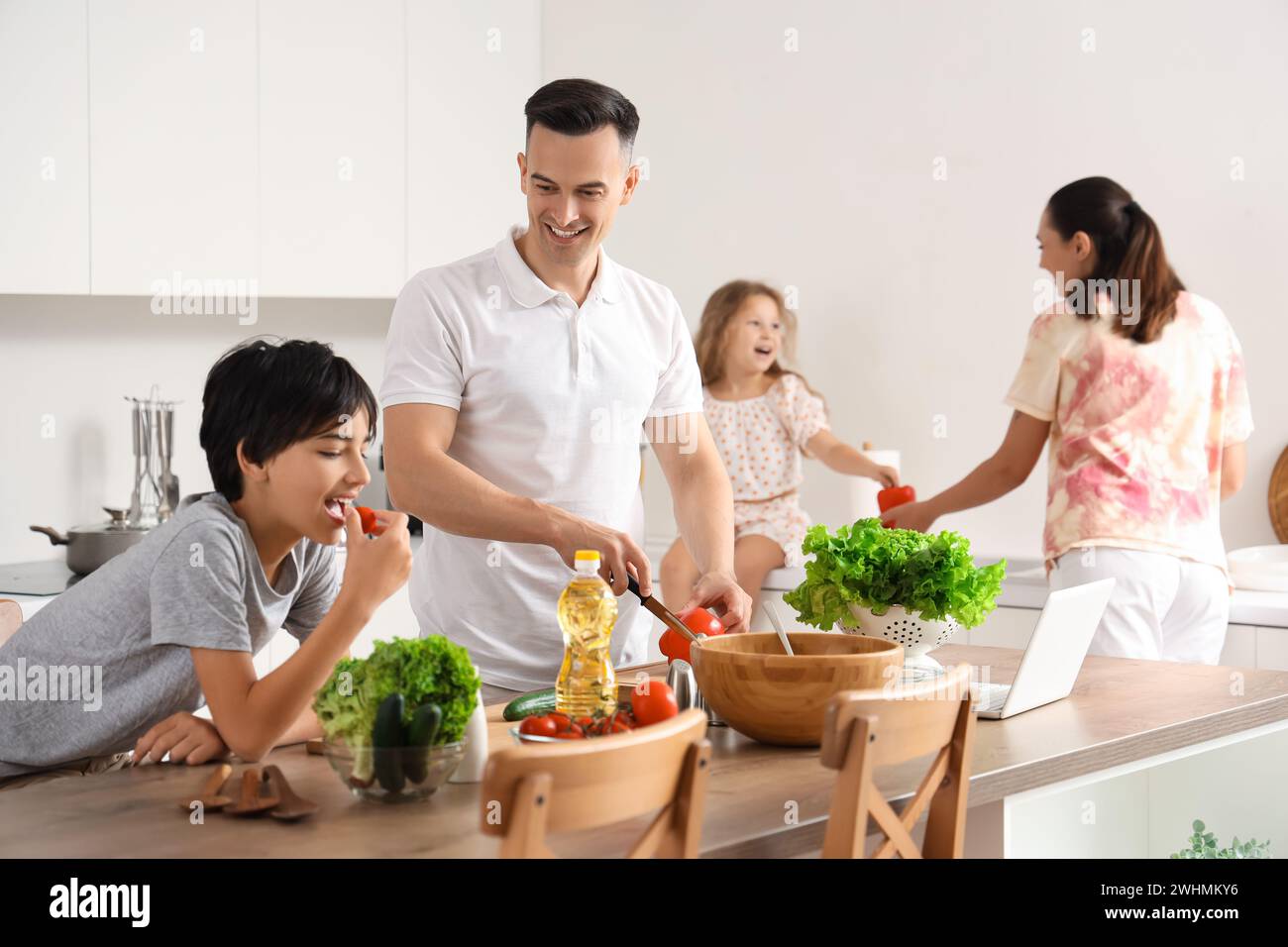 Little boy with his father cooking in kitchen Stock Photo - Alamy