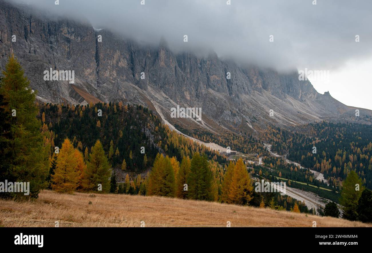 Dolomite mountain peaks covered in fog during sunrise Stock Photo - Alamy