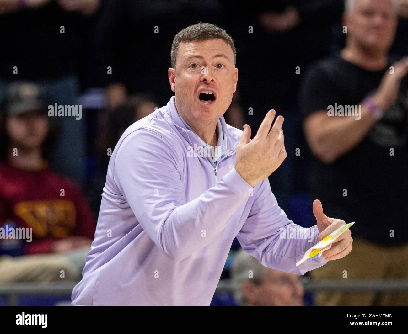 James Madison coach Mark Byington signals to the team during the first
