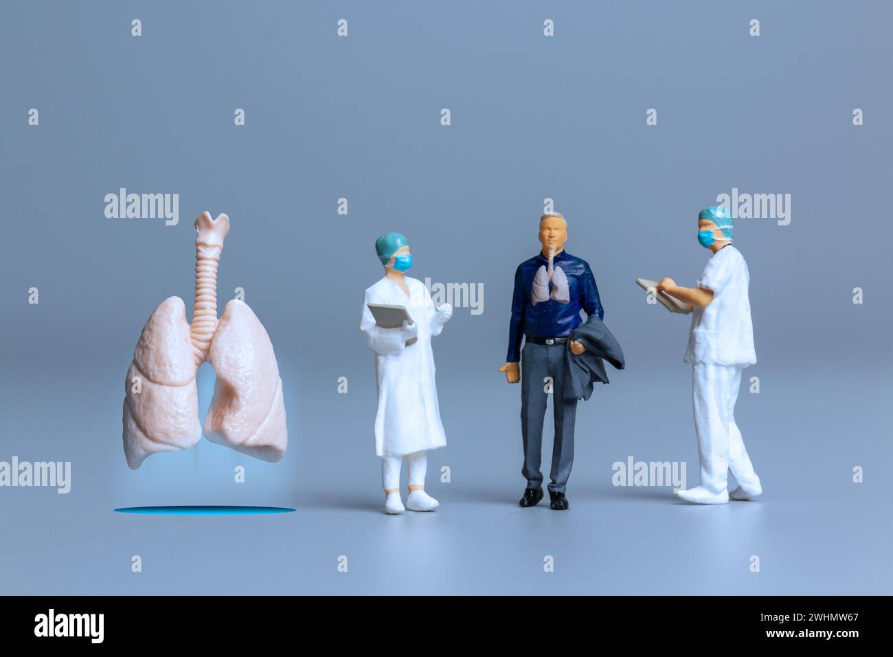 Miniature Doctors study and treat large human lungs, World Health Day concept Stock Photo