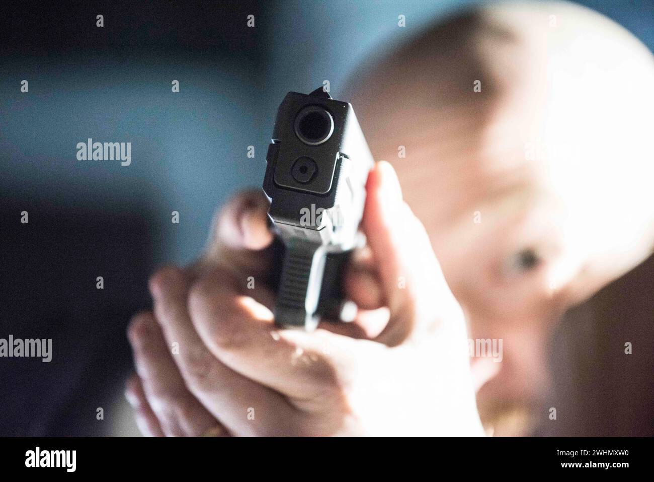 An attacker with a gun Stock Photo