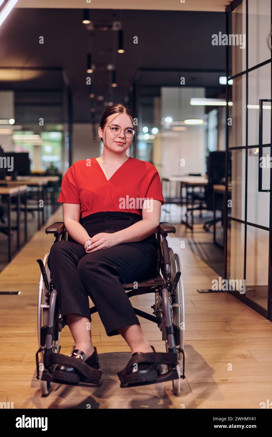 A modern young businesswoman in a wheelchair is surrounded by an ...