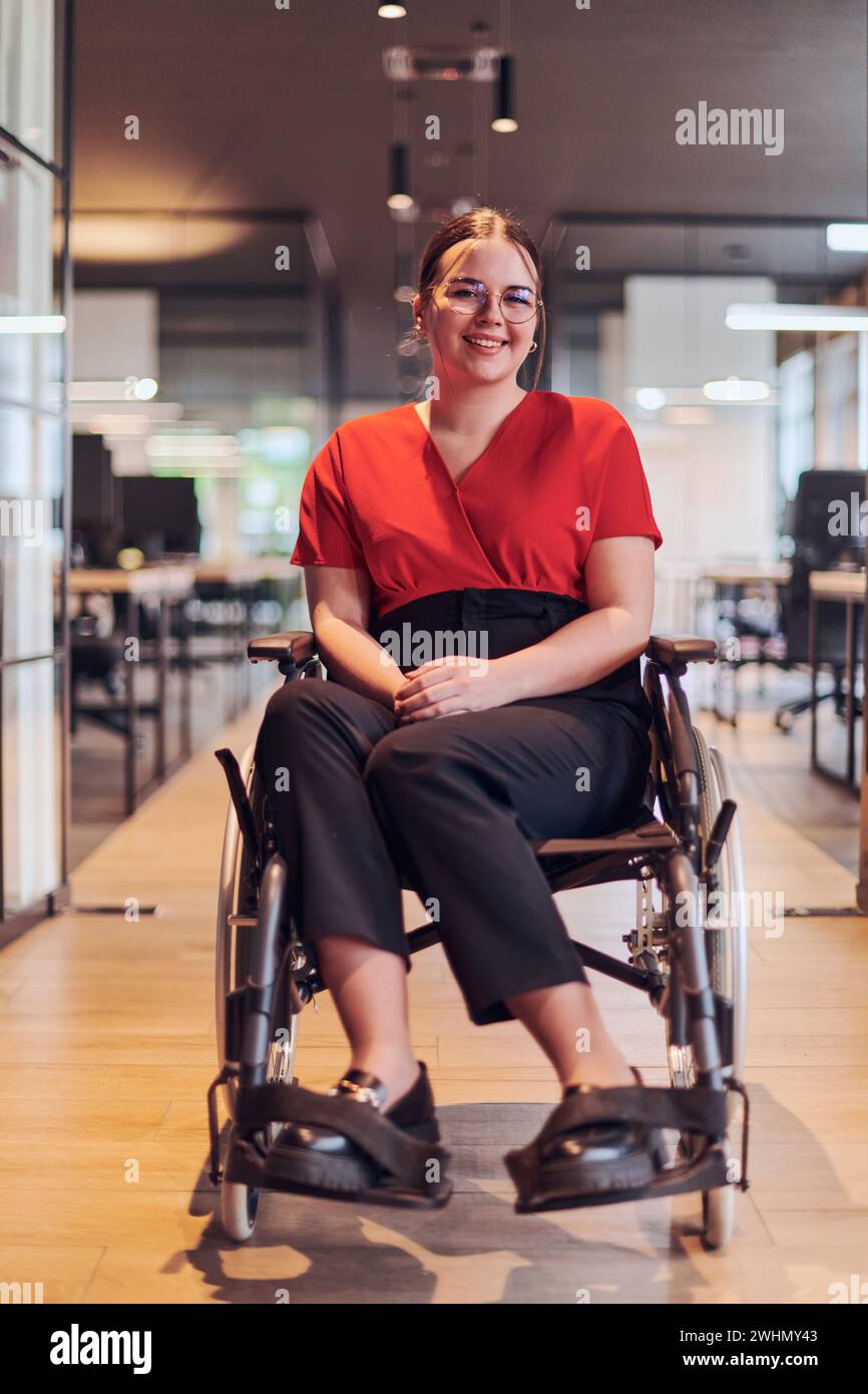 A modern young businesswoman in a wheelchair is surrounded by an ...