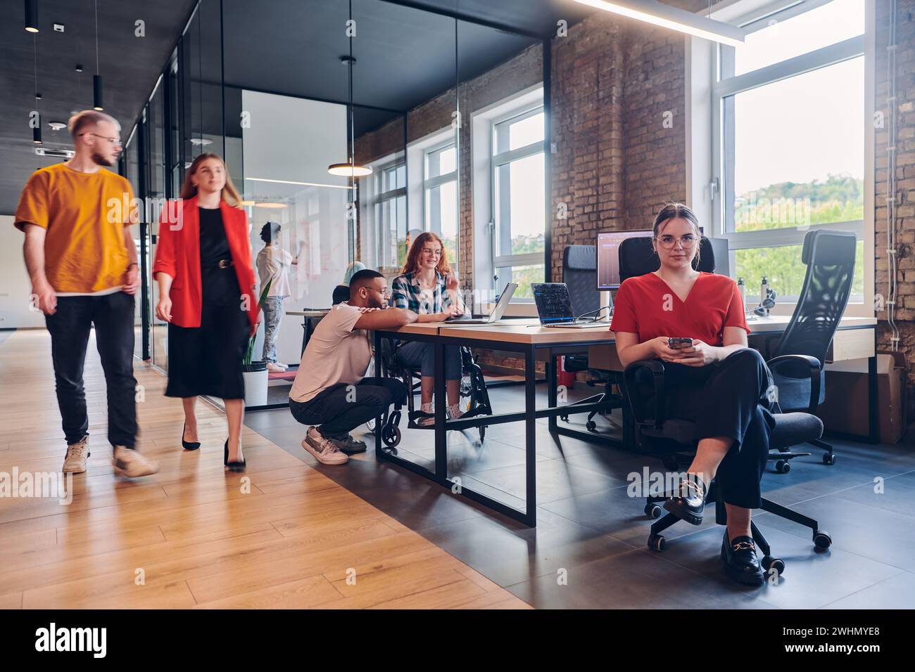 A diverse group of business professionals collaborates in a modern ...