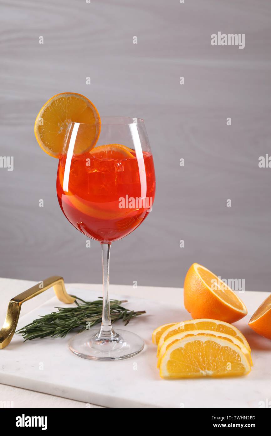 Glass of tasty Aperol spritz cocktail with orange slices and rosemary ...