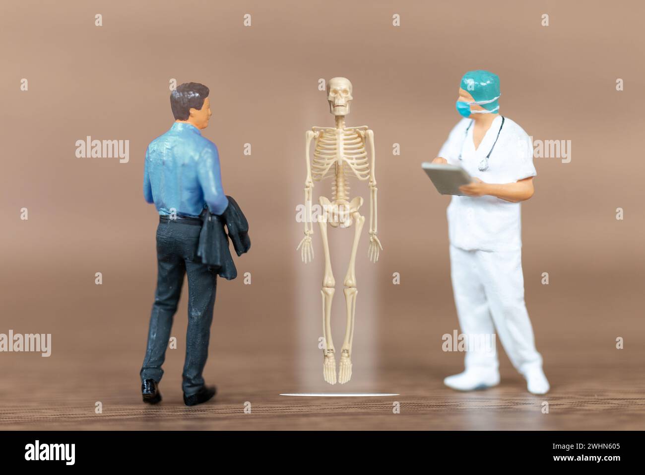 Miniature people patients are discussed  by an orthopedic physician Stock Photo